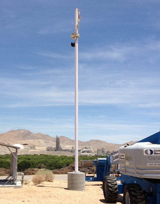 Installed pole in a desert site with cameras and communications hardware